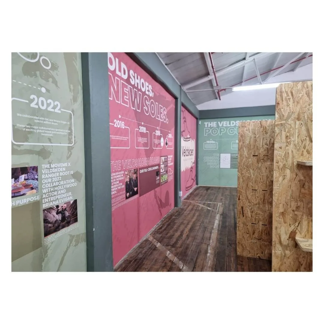Printed brand timeline wallpaper along an office corridor