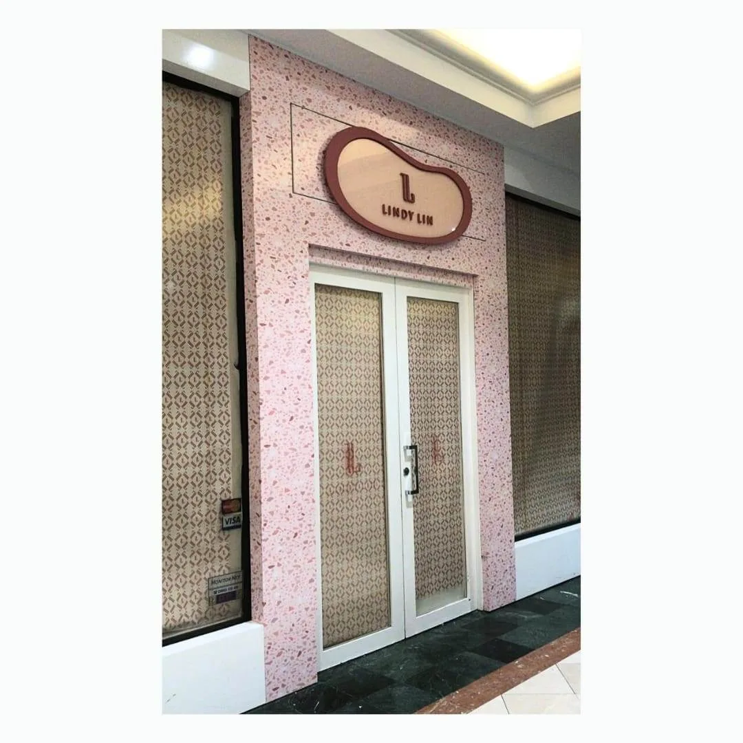 Retail shopfront finished in custom patterned printed wallpaper