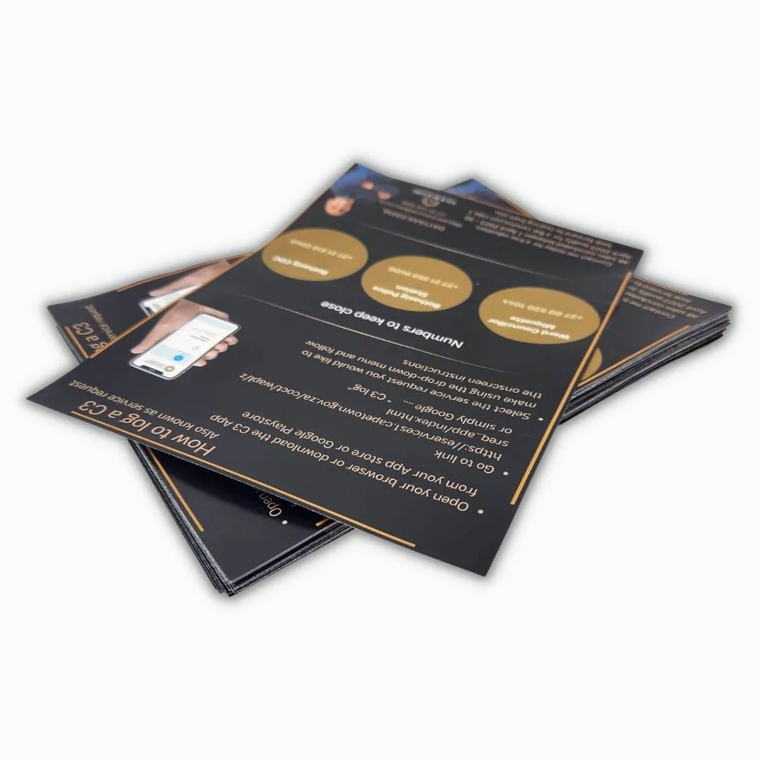 Dark full colour printed property flyers in a stack