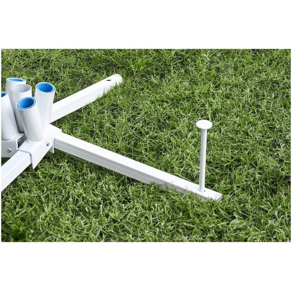 Steel flag fountain base pegged into grass with sockets for the flag poles