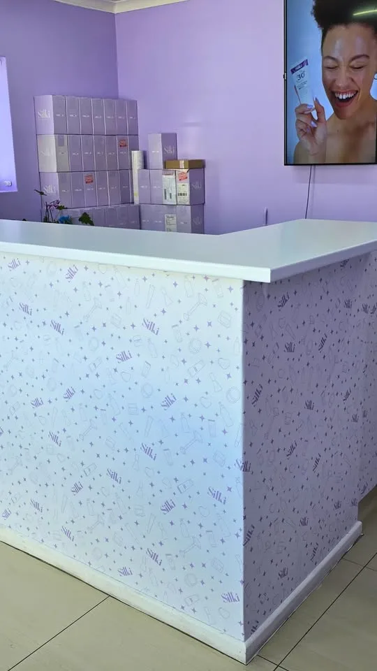 Branded reception counter and wall graphics at Silki's head office