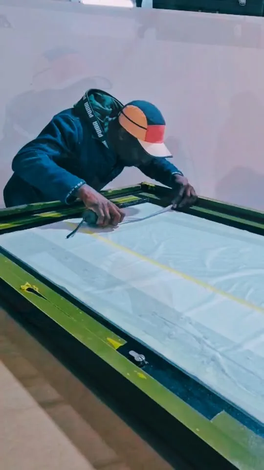 Geometric frosted vinyl being applied to a glass panel