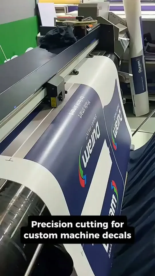 Custom vinyl decals being cut on the plotter for a paint machine wrap